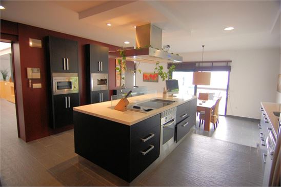 Designer kitchen with great views over pool to sea